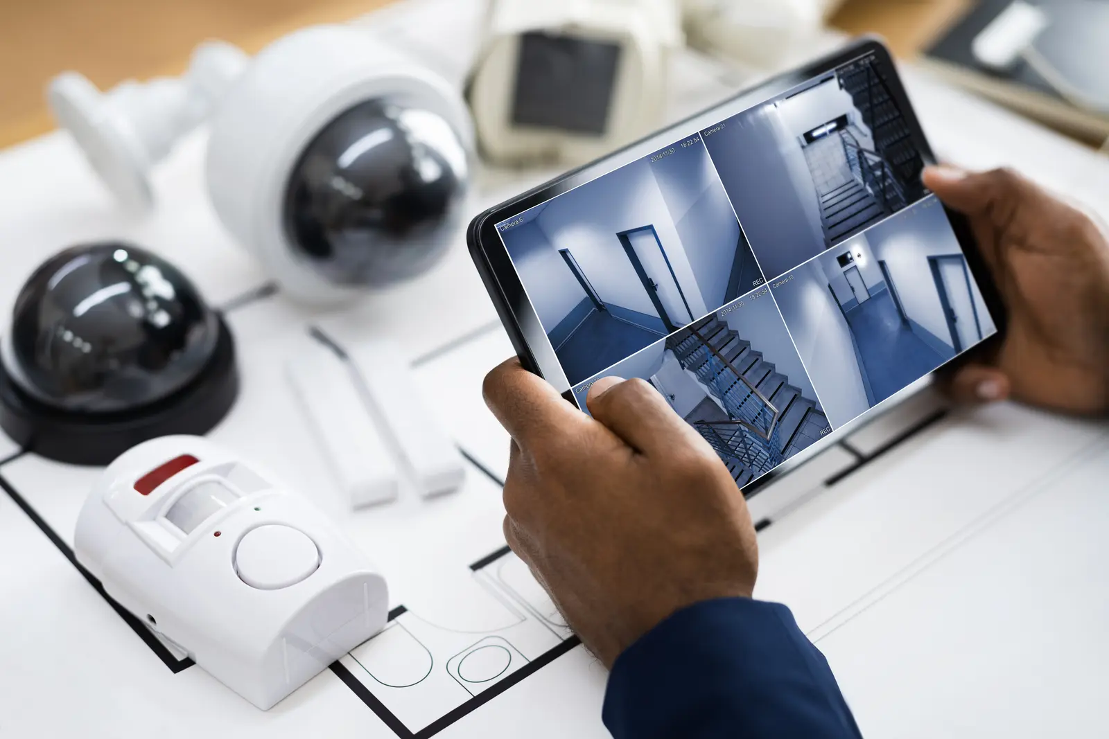 Caméra de surveillance professionnelle installée au plafond avec câblage réseau et boîtier de connexion visible